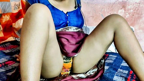 Desi woman in blue blouse and maroon skirt exposing pussy, legs spread on bed