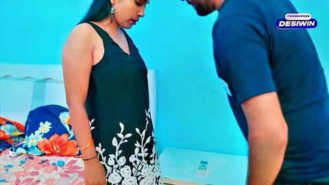 South Asian MILF in tight black dress stands as man gropes her ass from behind in bedroom