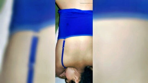 Asian woman in blue lingerie lifted from couch, teasing back view