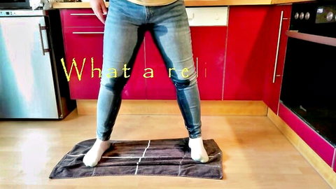 Amateur solo girl in kitchen stands barefoot on towel with wet piss-soaked jeans crotch