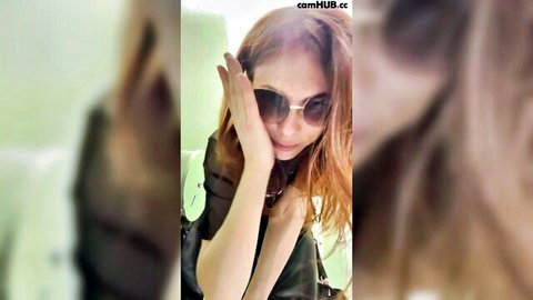 Alisa Beautiful redhead in changing room, seductive pose with sunglasses