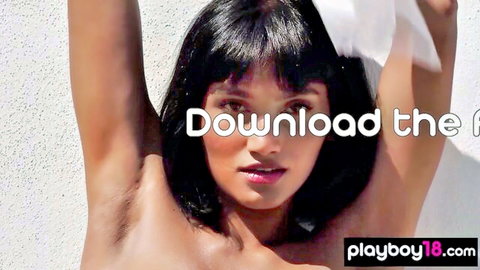 Asian babe with black hair posing topless, arms up exposing underarms