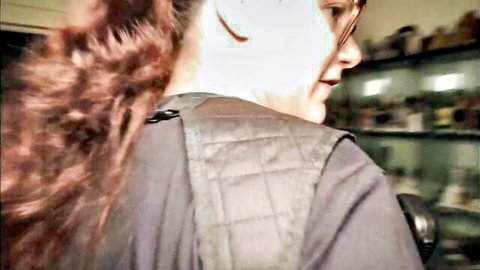 Red-haired white cop in tactical vest raiding stash house scene
