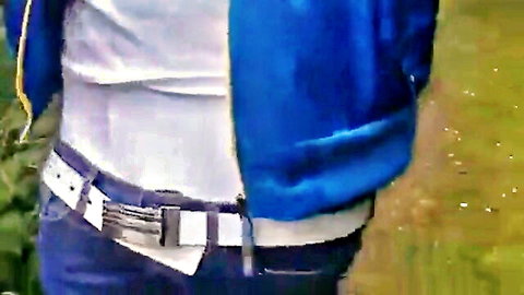 Guy sagging jeans outdoor, blue jacket open showing white underwear waistband