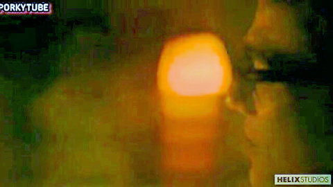Blurry artistic gay porn scene with warm orange glow and shadows