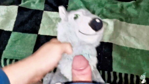 Amateur hand shoves hard pink cock into smiling white wolf plush toy mouth