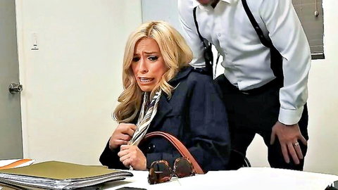 Blonde MILF in open trench coat grabbed by suited man from behind at office desk