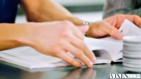 Natalia Starr and Xander Corvus hands sharing book and cards intimately