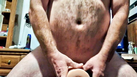 Hairy man masturbates with stroker toy until he cums inside
