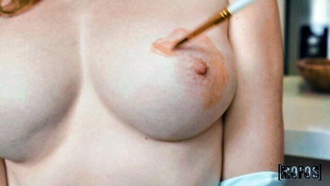 Yumi Sin sensually applying body paint to her bare breasts