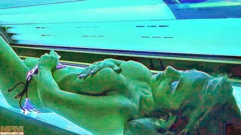 Nude woman teasing herself in solarium bed, solo masturbation