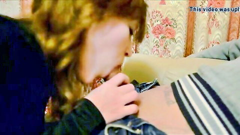 Blonde curly-haired wife sucking husband's thick cock while gripping base on bed
