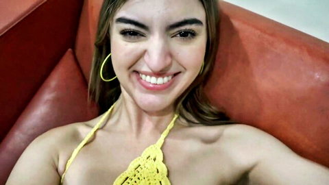 Curvy brunette smiling in skimpy yellow crochet bikini top teasing huge tits cleavage