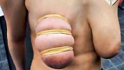 BDSM tit torture with yellow rubber bands binding large breasts
