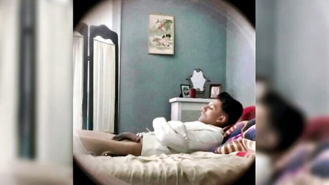 Bound Asian twink in white straightjacket restrained on bed eyes closed