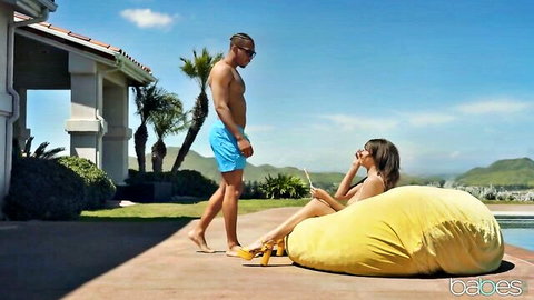 Alluring Latina babe in bikini lounging poolside with handsome guy