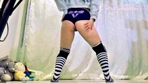 Miss Wednesday teases ass in tight purple shorts and striped stockings during sexy dance practice