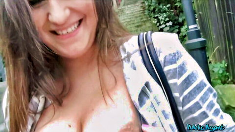 Cute brown-haired teen smiling with deep cleavage in Public Agent outdoor tease