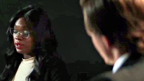 Sexy ebony woman in glasses and blazer stares passionately at suited white man in intense interracial close-up