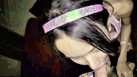 Asian tranny in pink top and sparkling headband, seductive close-up