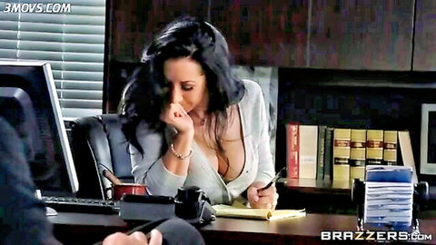 Jayden Jaymes in seductive office pose with deep cleavage