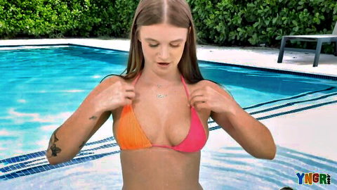 Sky Wonderland teasing in pink bikini by pool, showing cleavage
