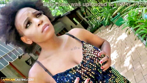 Sexy ebony babe with big tits and cleavage in sparkly sequin dress posing outdoors