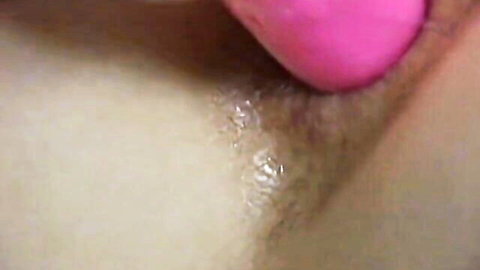 Pink dildo deeply inserted into hairy Asian woman's tight asshole close-up