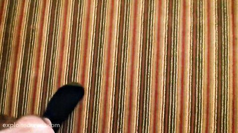 POV closeup of black socked foot on red striped carpet in casting room