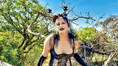 Gothic woman in black lace lingerie and gloves posing seductively outdoors