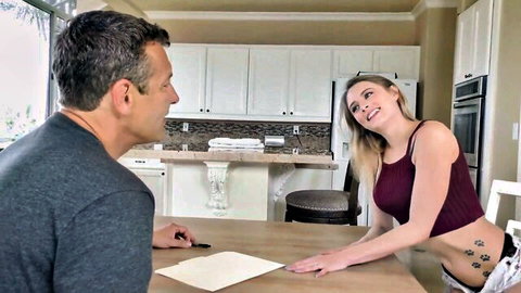 Kyler Quinn leans over table teasing Jay Romero, skinny blonde in tank top and shorts
