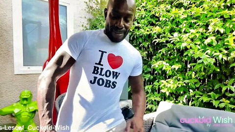 Muscular black bull wearing I love blow jobs t-shirt smiling teasing outdoors