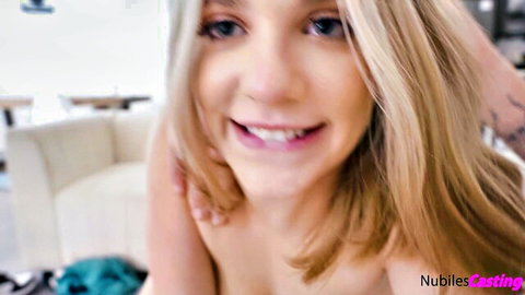 Smiling young blonde teen topless with huge tits in Nubiles casting closeup