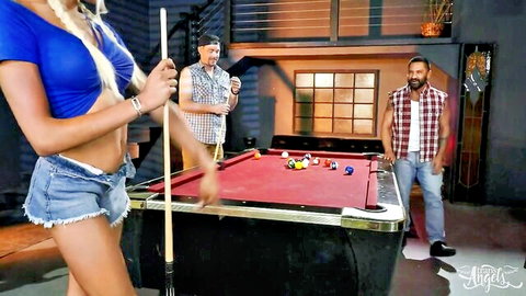 Blonde trans woman in tiny shorts bends over pool table, teased by two guys