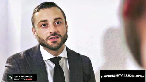 Bearded suited man in intense gaze for Raging Stallion gay flip fuck video