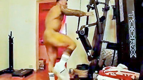 Muscular tattooed gay hunk naked on stepper machine exposing bare ass and white socks