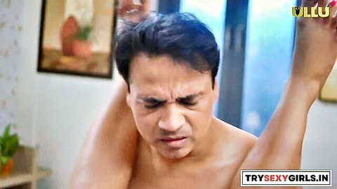 Intimate couple scene from Adla Badli Part-3 Indian web series, man shirtless with woman leg raised