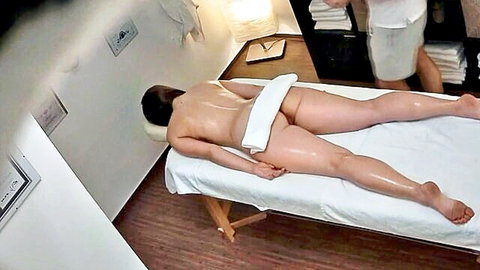 Nude Asian woman lying on massage table in erotic spa scene