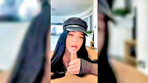 Seductive PAWG with black hair and beret teases tongue out in sheer top