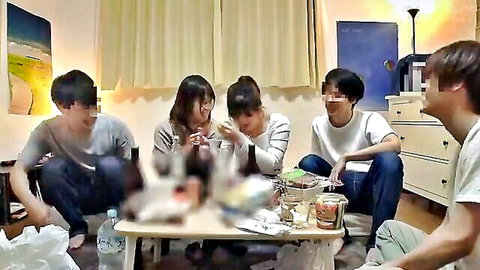 Young Japanese friends gathered around table eating ramen and snacks