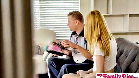 Blonde stepdaughter sitting with stepdad on couch, teasing for Father's Day - My Family Pies