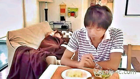 Asian mom rests under blanket as younger man eats, seductive handjob tease