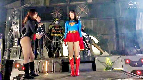 Asian Supergirl cosplay babe in skimpy outfit with leather domme and costumed studs