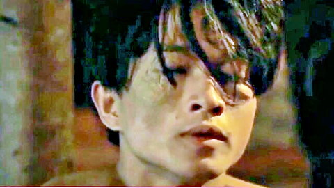 Intense closeup of sexy Asian guy with wet hair and glasses staring sensually