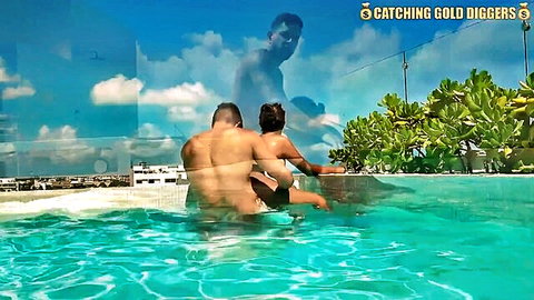 Sexy Latina woman embraced by muscular man at sunny poolside