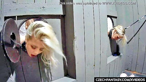 Blonde woman restrained in stocks for intense gangbang orgy