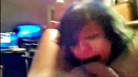 Blurry close-up of purple-haired woman in intense oral during homemade threesome