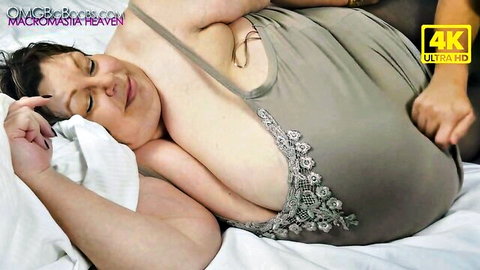 BBW MILF with massive tits squeezed by hand while lying on bed in tank top