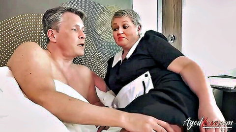 Mature Candy Cummings in nurse dress with Marc Kaye on bed