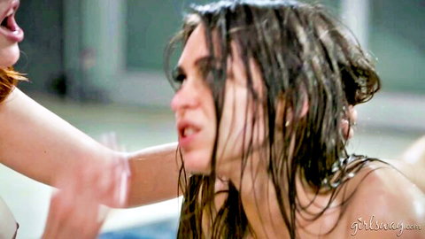 Riley in wet lesbian pool embrace with redhead, nude and steamy